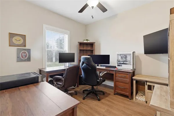 a view of a workspace with furniture and a window