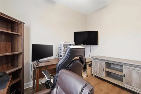 a view of a workspace with furniture and a flat screen tv