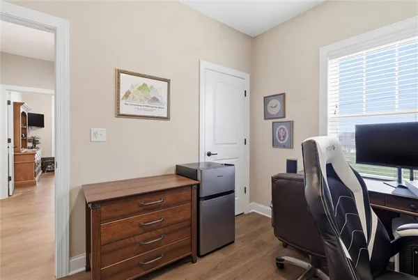 a view of a workspace with furniture and a window