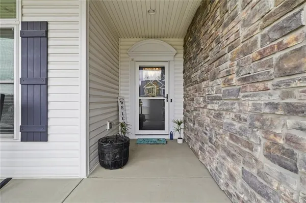 a view of a two chairs and table in the garden