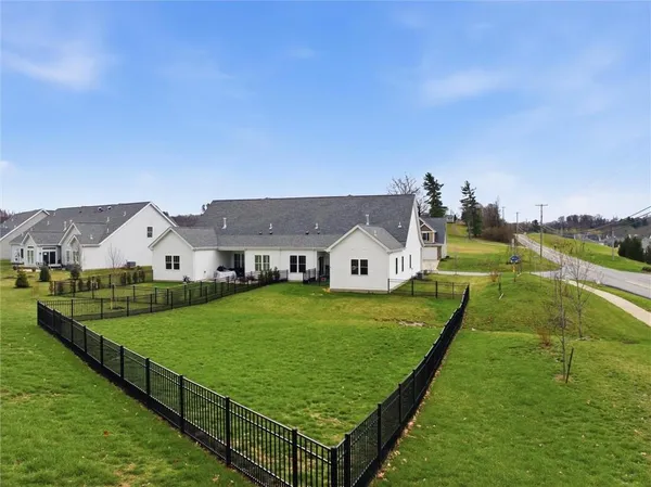 an aerial view of residential houses with outdoor space and city view
