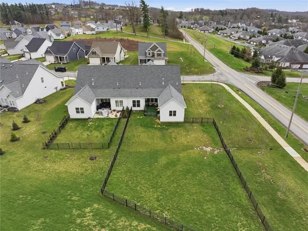 an aerial view of residential houses with outdoor space and swimming pool