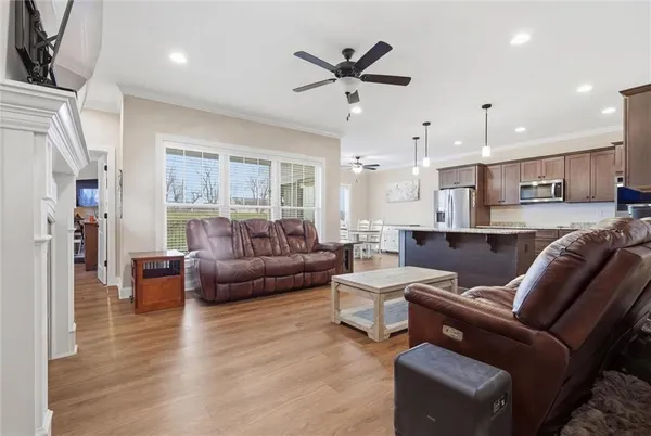 a living room with furniture and kitchen view