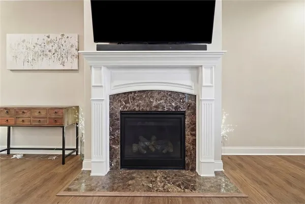 a living room with a fireplace and a flat screen tv