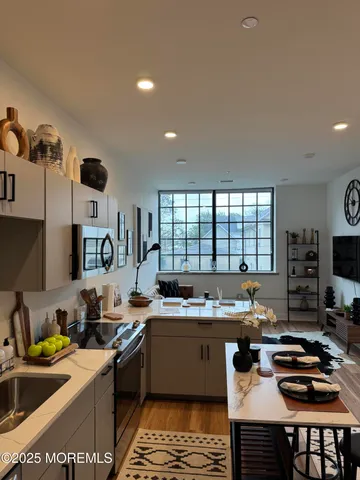 a kitchen with a sink stove top oven and cabinets