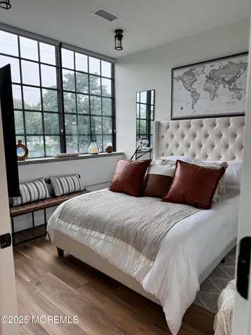 a bedroom with bed and large window