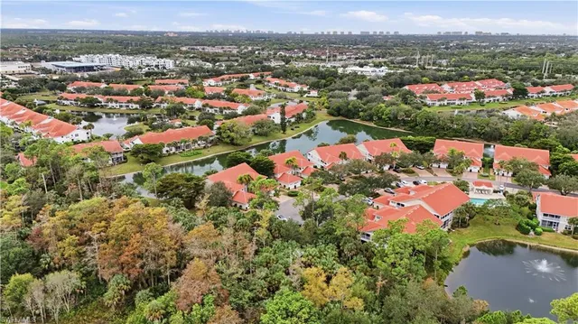 a view of a hallway to a livingroom with furniture