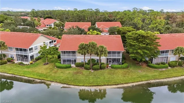 an aerial view of residential houses with outdoor space and trees