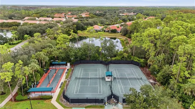 an aerial view of multiple houses with a swimming pool