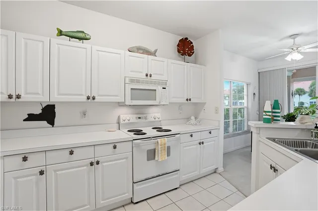 a view of kitchen with sink and living room