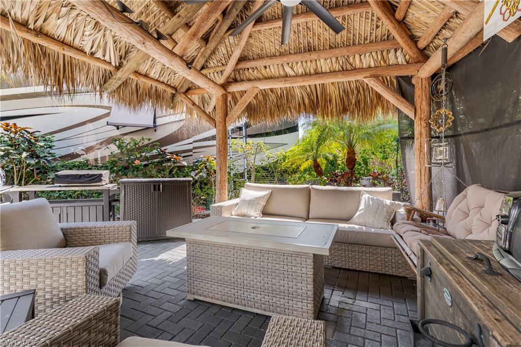 13580 Snook Circle Naples, FL 34114 - Photo 1 of 33 a roof deck with couches and wooden fence