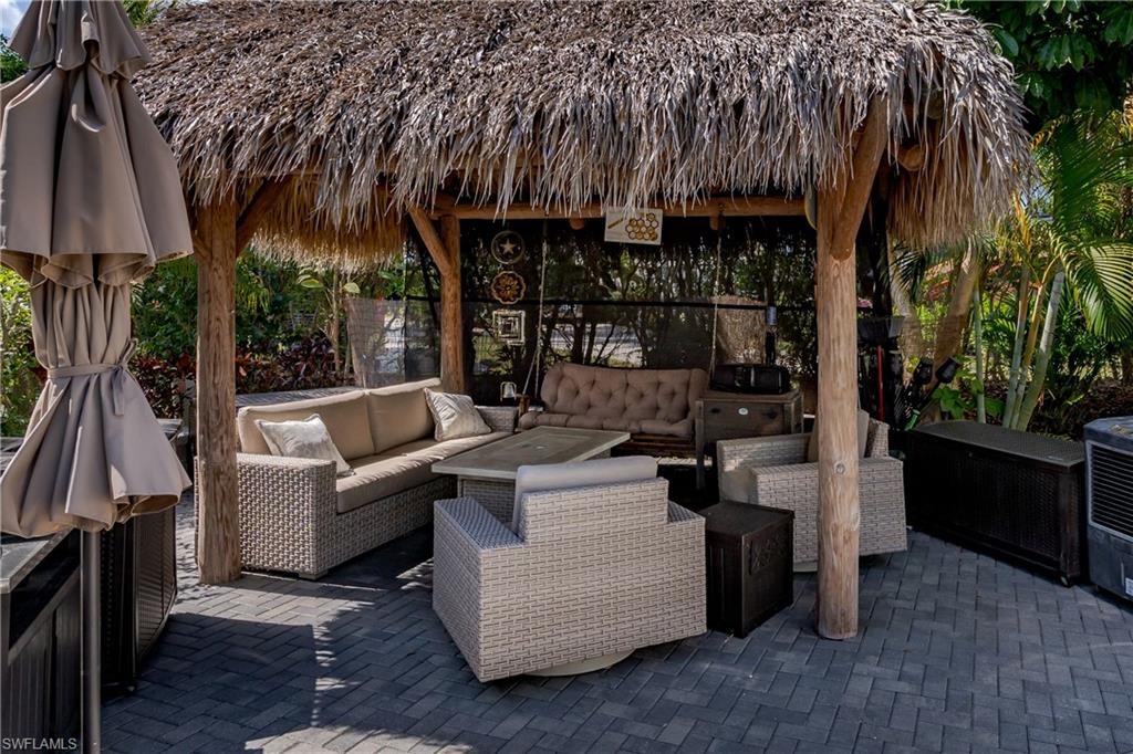 13580 Snook Circle Naples, FL 34114 - Photo 8 of 33 a view of outdoor kitchen and dining area with furniture