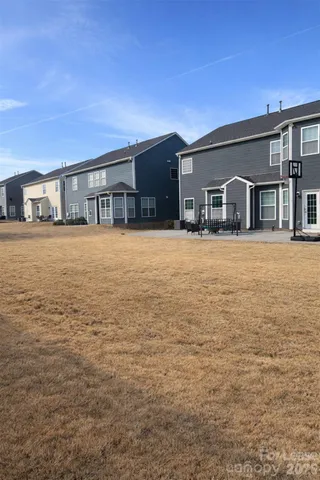 a front view of house with yard and trees
