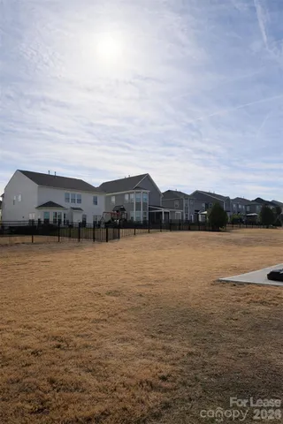 a house view with swimming pool and mountains in the background