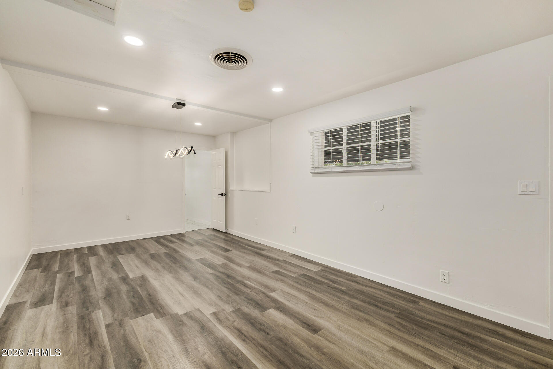 533 West 18th Street Tempe, AZ 85281 - Photo 11 of 52 an empty room with wooden floor and windows