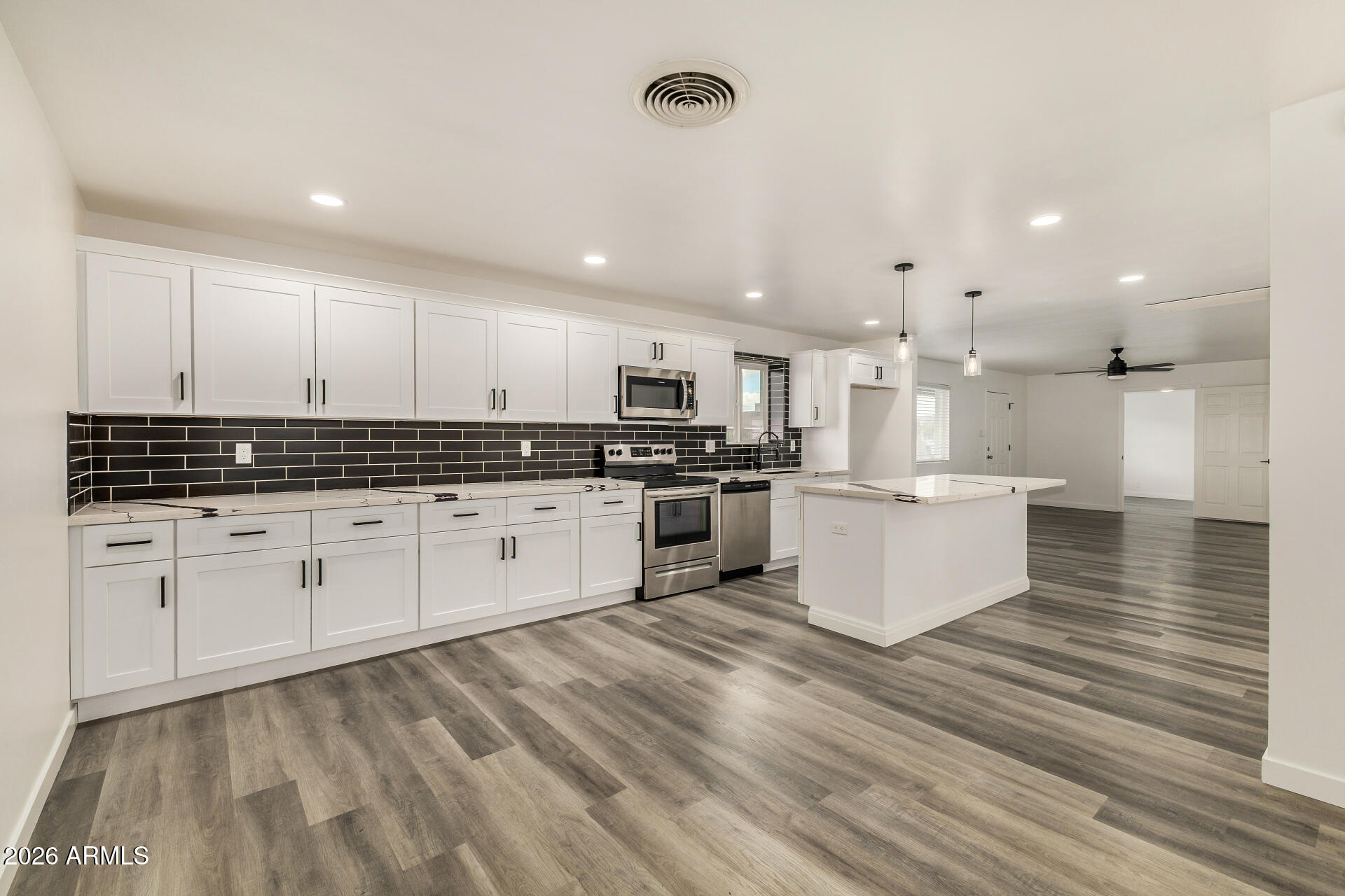 533 West 18th Street Tempe, AZ 85281 - Photo 16 of 52 a large kitchen with stainless steel appliances granite countertop a stove a sink and white cabinets