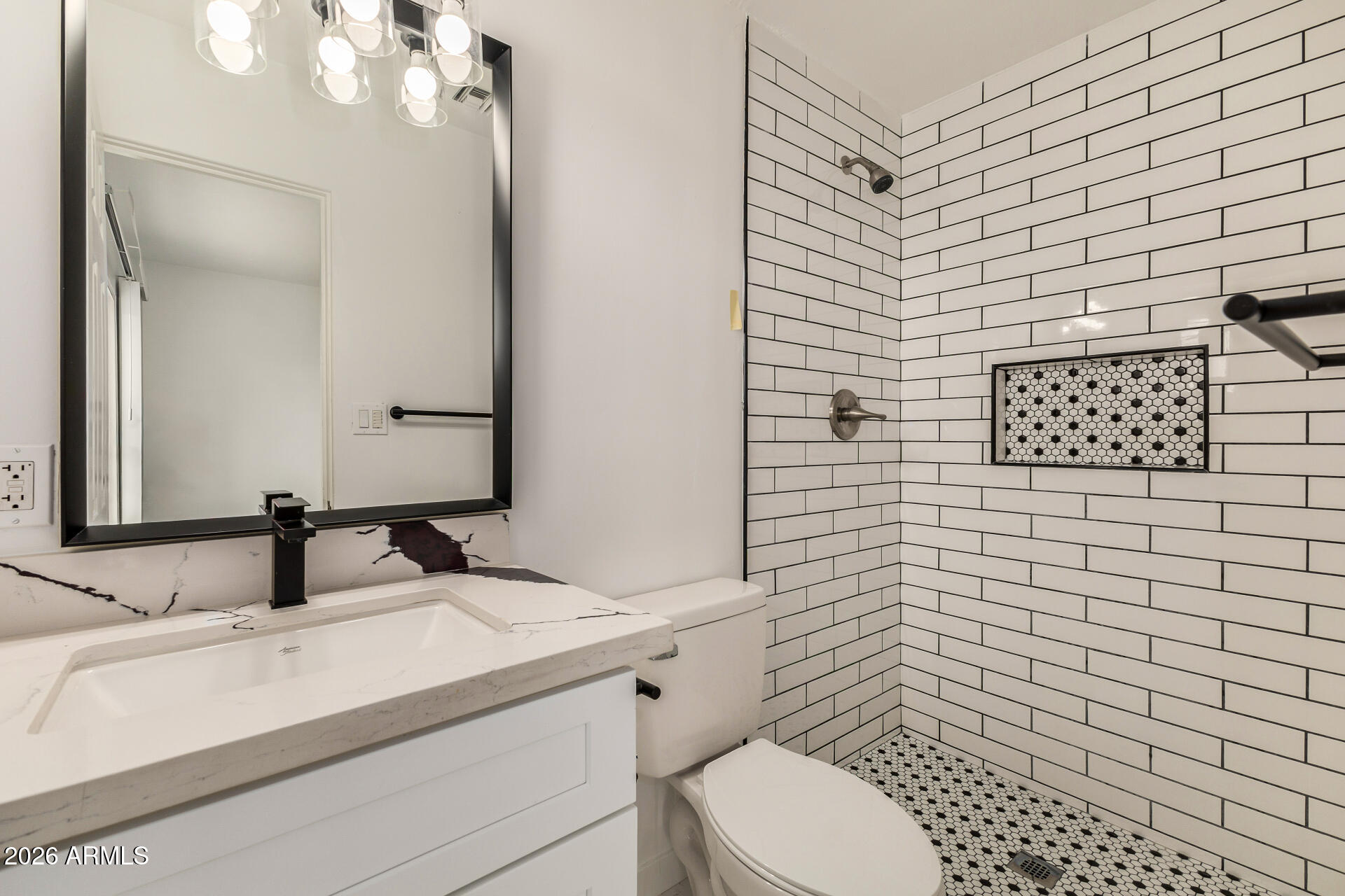 533 West 18th Street Tempe, AZ 85281 - Photo 25 of 52 a bathroom with a toilet sink vanity and mirror
