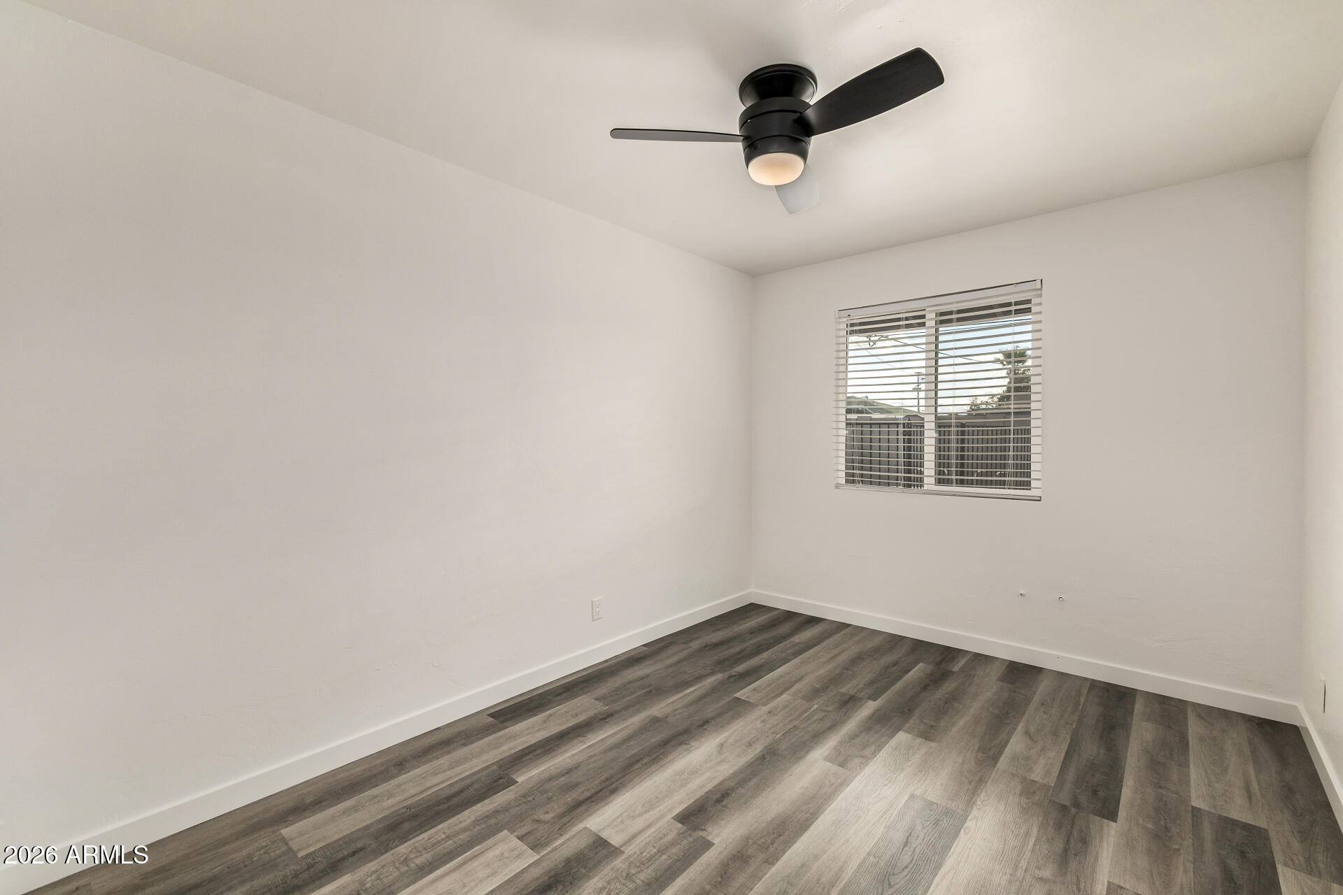 533 West 18th Street Tempe, AZ 85281 - Photo 27 of 52 an empty room with a window and a ceiling fan