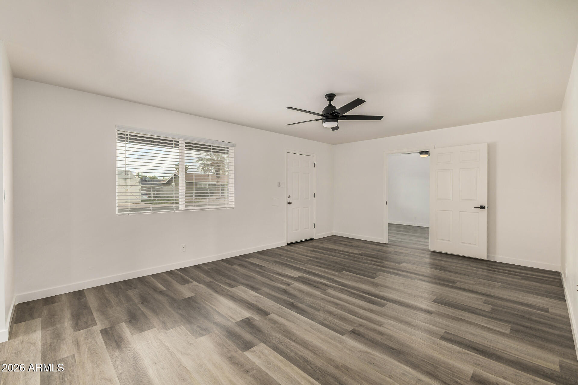 533 West 18th Street Tempe, AZ 85281 - Photo 8 of 52 a view of empty room with wooden floor and fan