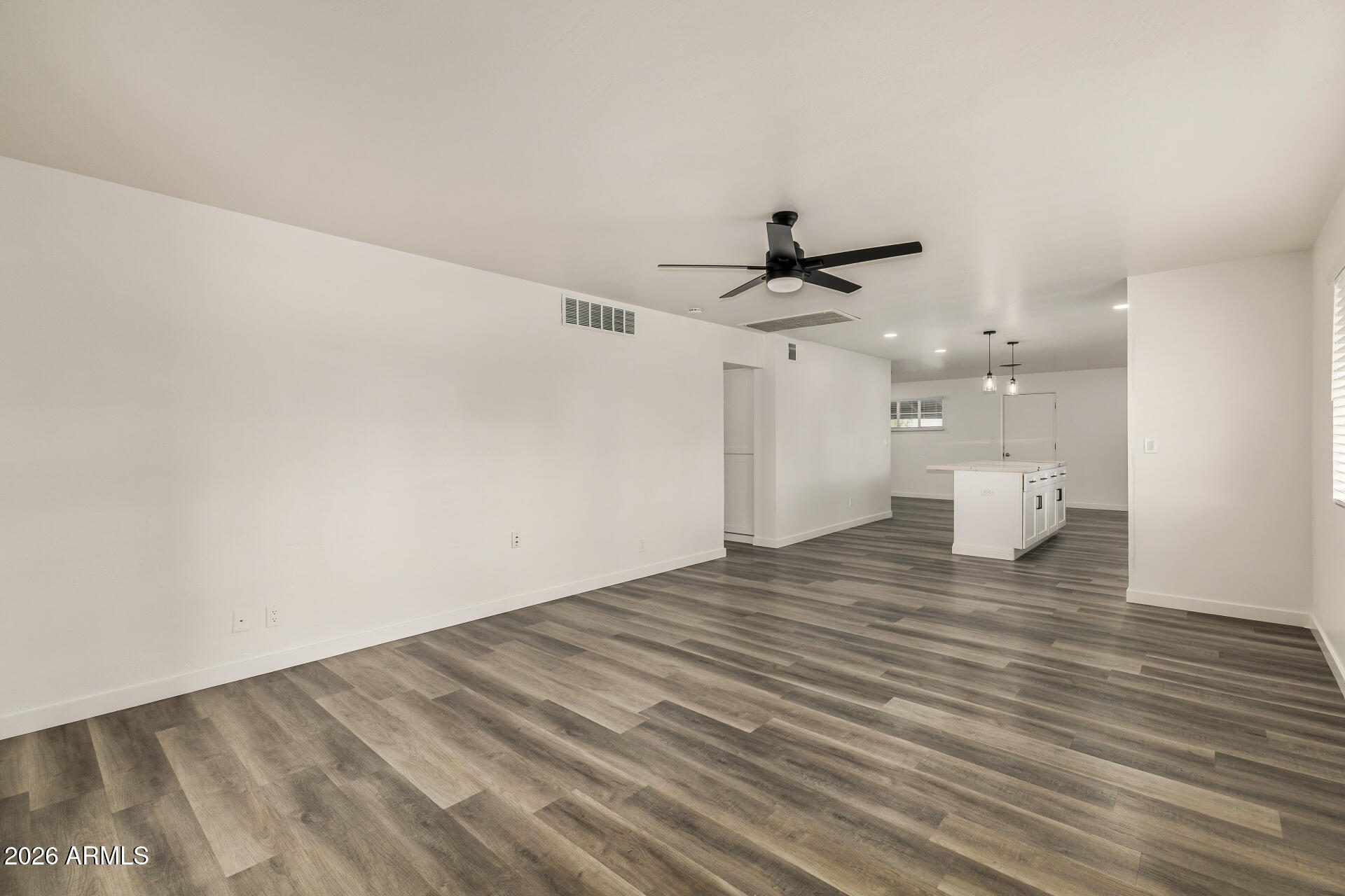 533 West 18th Street Tempe, AZ 85281 - Photo 9 of 52 a view of empty room with wooden floor and white walls