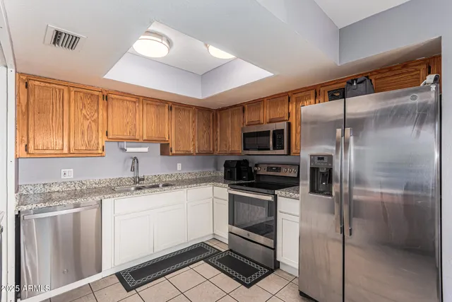 a kitchen with a sink stove and refrigerator