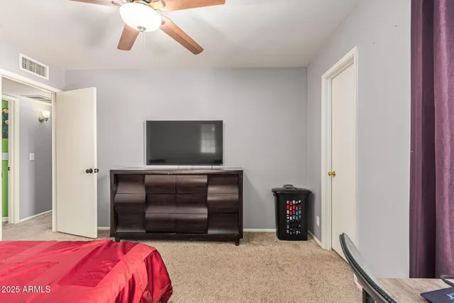 a bedroom with a bed and a television