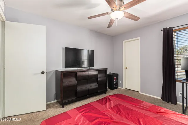 a bathroom with a granite countertop toilet a sink and a shower curtain