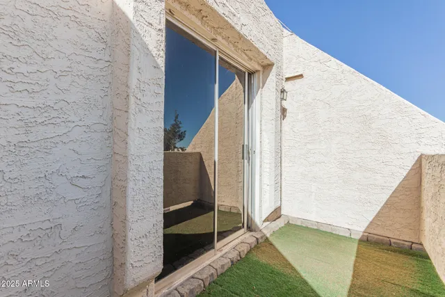 a terrace view with two chairs and a table