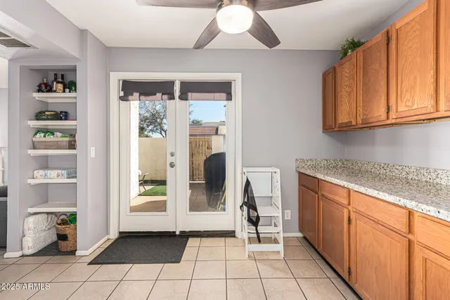 a kitchen with a refrigerator sink and cabinets