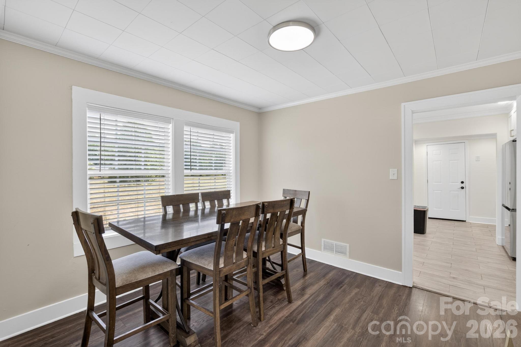 2076 Connelly Springs Road Lenoir, NC 28645 - Photo 9 of 47 a view of a dining room with furniture and wooden floor