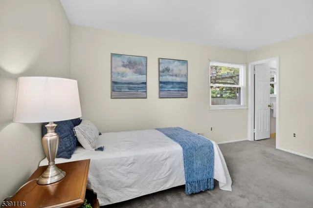 a bedroom with a bed and lamp with window