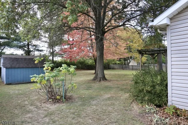 an aerial view of a house with outdoor space and street view
