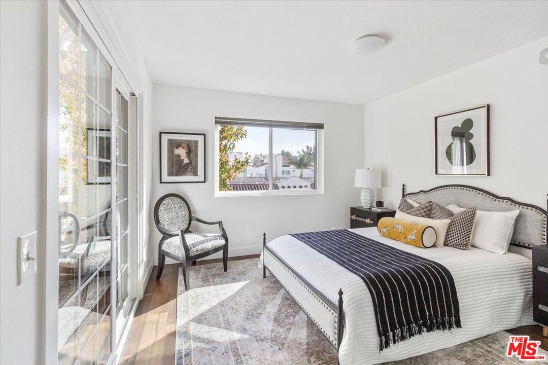 10960 Bluffside Drive, Unit 201 Studio City, CA 91604 - Photo 12 of 23 a bedroom with a bed and wooden floor