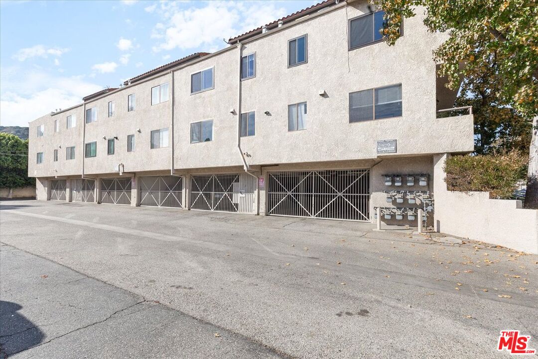 10960 Bluffside Drive, Unit 201 Studio City, CA 91604 - Photo 21 of 23 a large building with a large parking space near a road