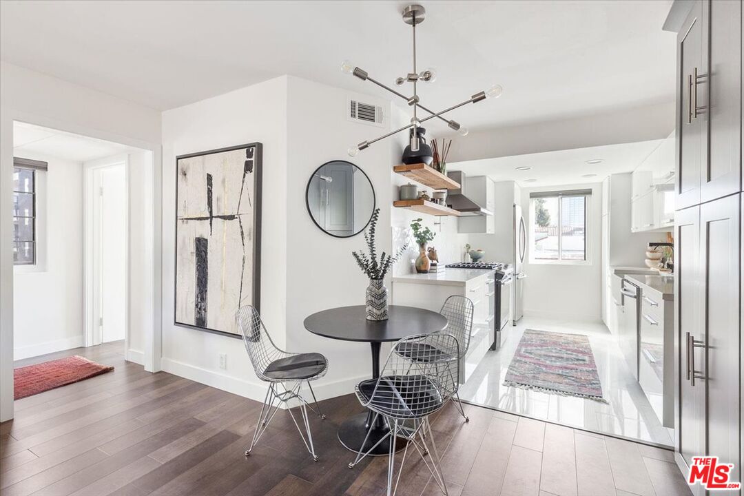 10960 Bluffside Drive, Unit 201 Studio City, CA 91604 - Photo 5 of 23 a very nice looking room with a large mirror and a dining table with chandelier