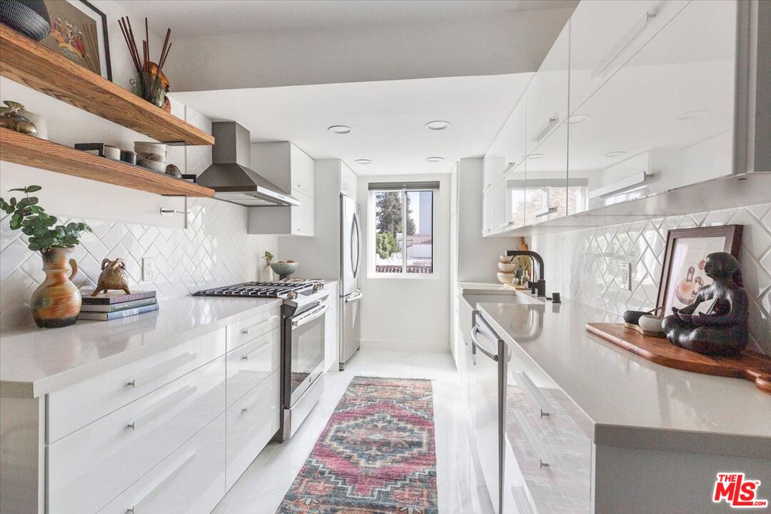 10960 Bluffside Drive, Unit 201 Studio City, CA 91604 - Photo 7 of 23 a kitchen with stainless steel appliances granite countertop a sink and cabinets
