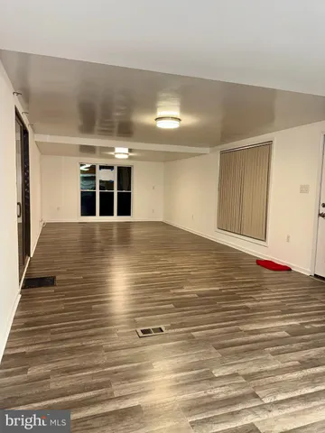 a view of a room with wooden floor