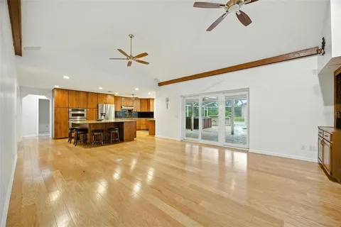 a view of a livingroom with furniture ceiling fan and window