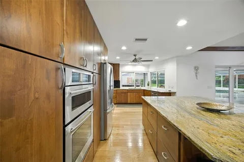 a large white kitchen with a large window