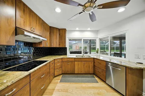 a kitchen with stainless steel appliances granite countertop a sink and stove