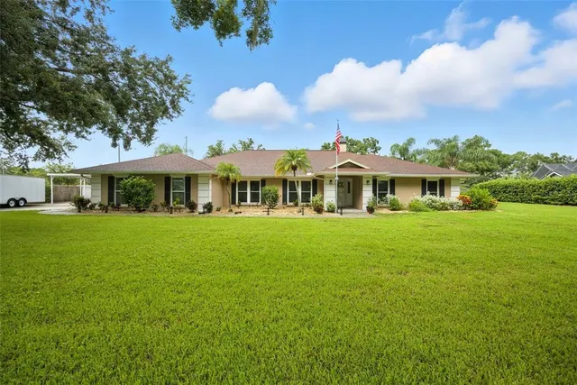 a front view of a house with yard and green space