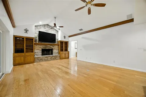 a view of a room with wooden floor and windows