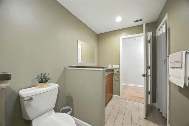 an empty room with a window and a ceiling fan