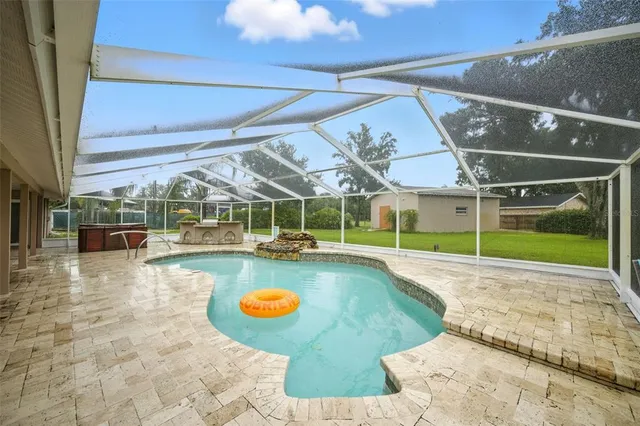 a view of a swimming pool with an outdoor seating