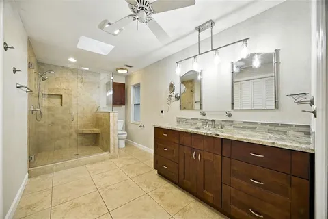 an empty room with ceiling fan and window