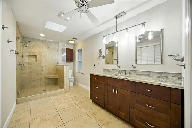 an empty room with ceiling fan and window