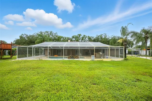 a view of an house with backyard space and garden