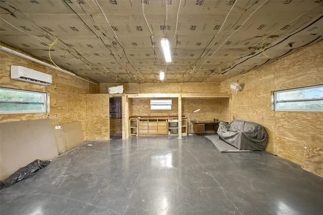 an aerial view of residential house with outdoor space and trees all around