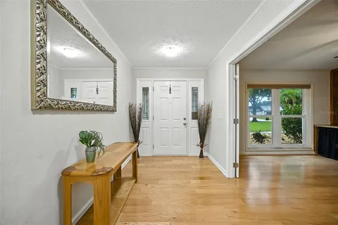 a view of a hallway to a livingroom with furniture