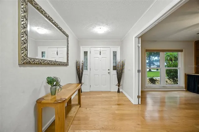 a view of a hallway to a livingroom with furniture